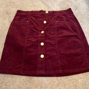 NEVER WORN maroon mini skirt, still has tags, great condition, size 0.